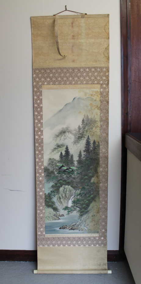 A 20thC Chinese scroll painting of a landscape, bears artists seal and signature, 185cm x 52cm.