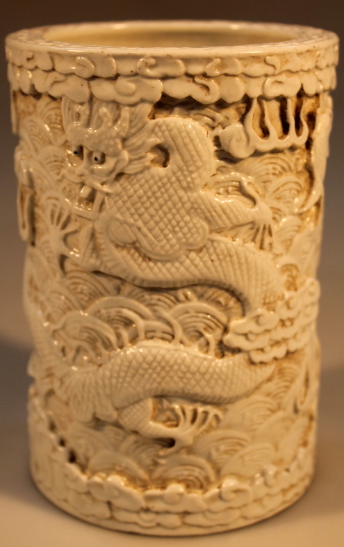 A Chinese export brush pot, relief decorated with dragons and fish, 15cm high.