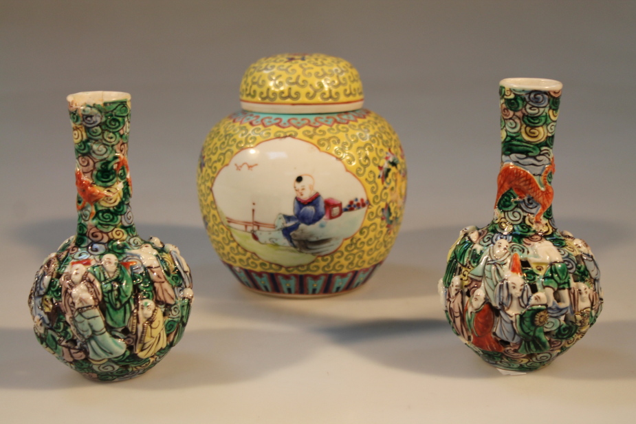 A pair of small Chinese bottle vases, relief moulded with figures; and a yellow ground 20thC