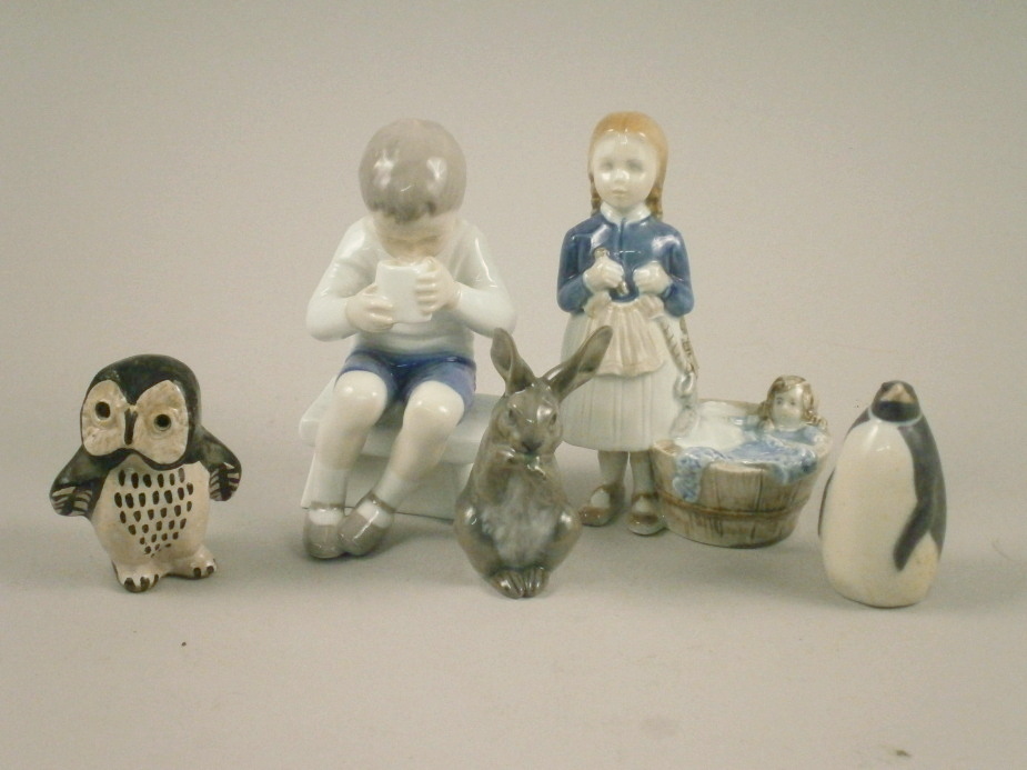 A group of four Scandinavian ceramic figures, to include a Bing & Grondahl figure of a boy seated,