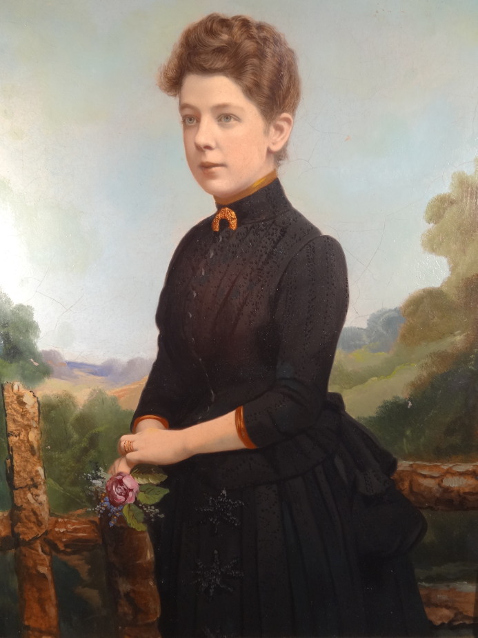 19thC School. A study of a lady in a landscape facing left, in black dress holding a posy of