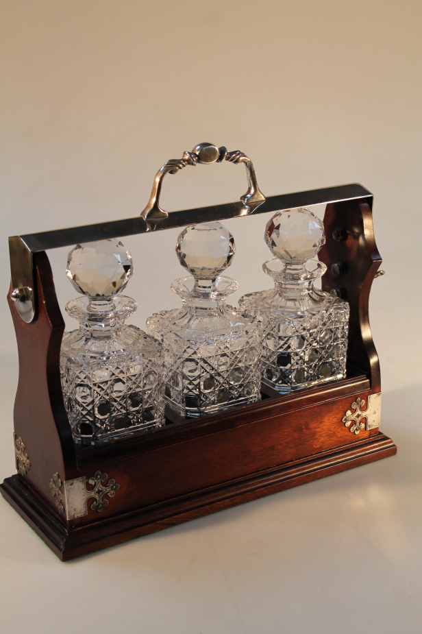 A tantalus, with three decanters.