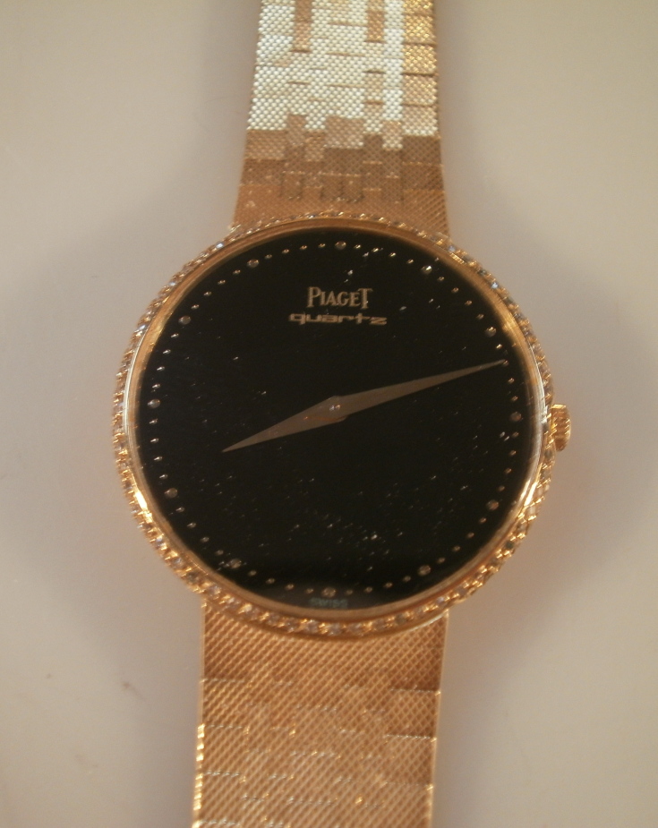 A Piaget quartz wristwatch, central dial of black background with tiny inset stones, watch head