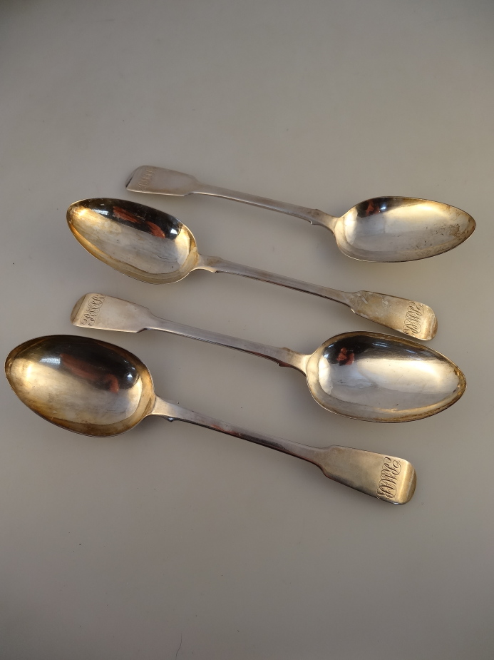 A set of four George III silver fiddle pattern table spoons, London 1810, maker James Beebe, 7oz.