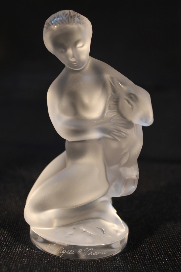 A Lalique figure of a naked girl holding a deer, 11.5cm high.