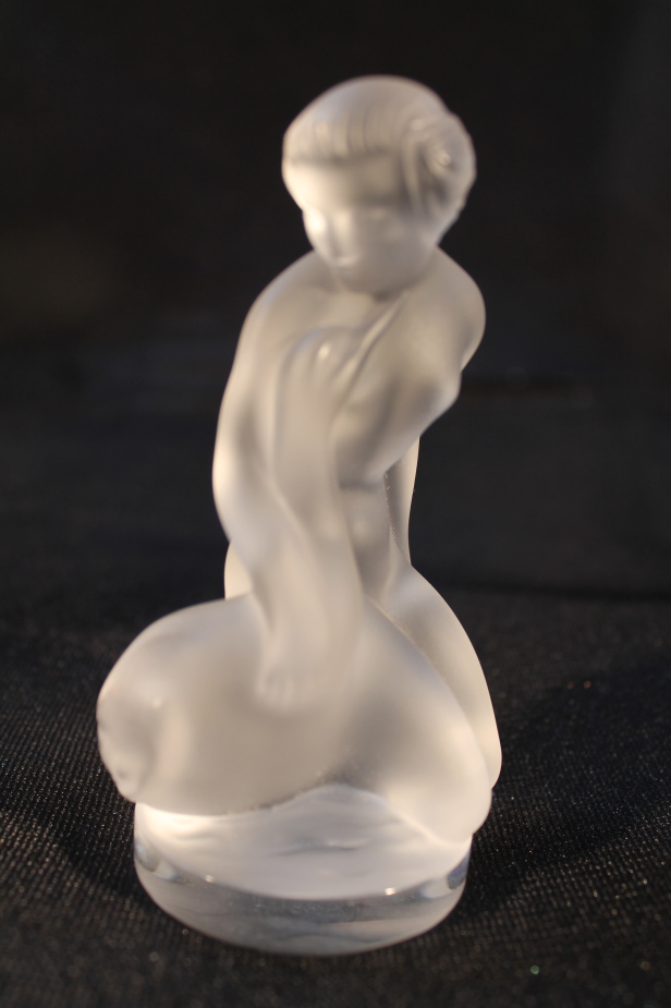 A Lalique figure, of a naked girl holding a swan, 11.5cm high