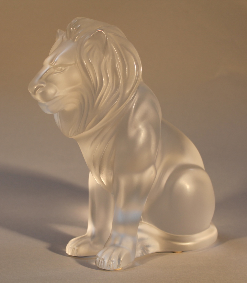 A Lalique figure of a lion, etched signature to base, dated 17.11.90 20cm high.