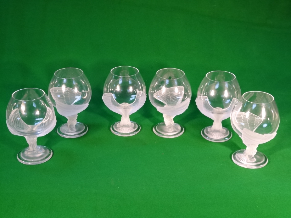 A set of six brandy balloons, with eagle stems, etched N 1987 France, and two decanters.