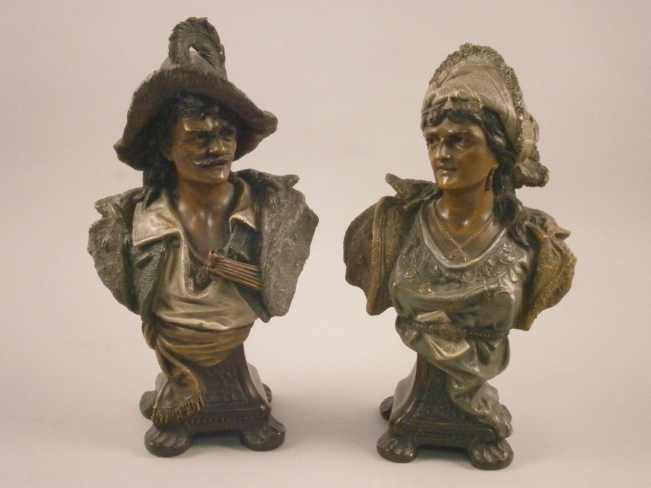 A pair of late 19thC Austrian terracotta busts, of gentleman and a lady, on a tapering base with