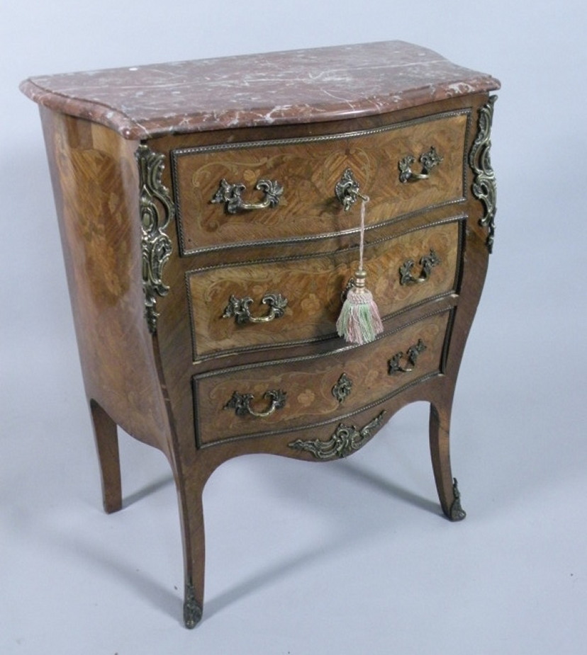 A Continental serpentine marquetry commode, with a rouge marble top above three drawers, gilt