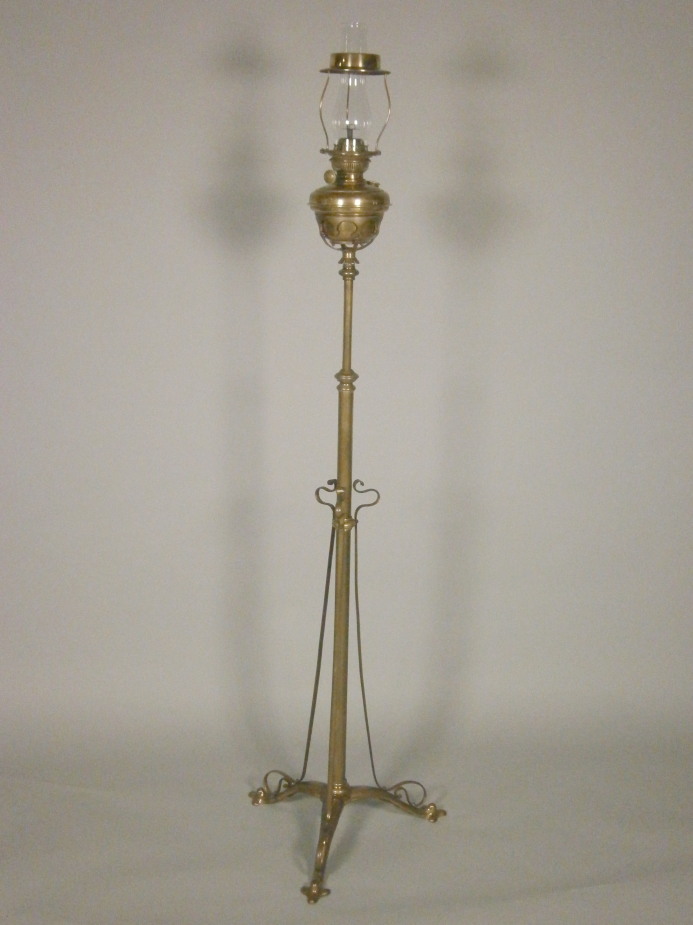 A late Victorian Art Nouveau style brass adjustable standard lamp, three shaped feet, 173cm high