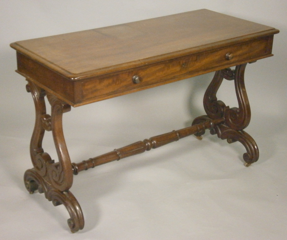 An early Victorian mahogany library table, the top with a moulded edge above one long frieze