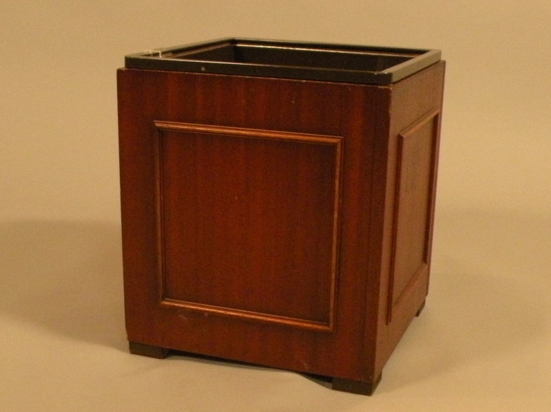 A mahogany waste paper bin, with panelled sides and a metal liner, 33cm wide.