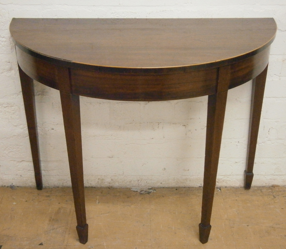 A George III mahogany demi-lune side table, with boxwood strung borders and square tapering legs,