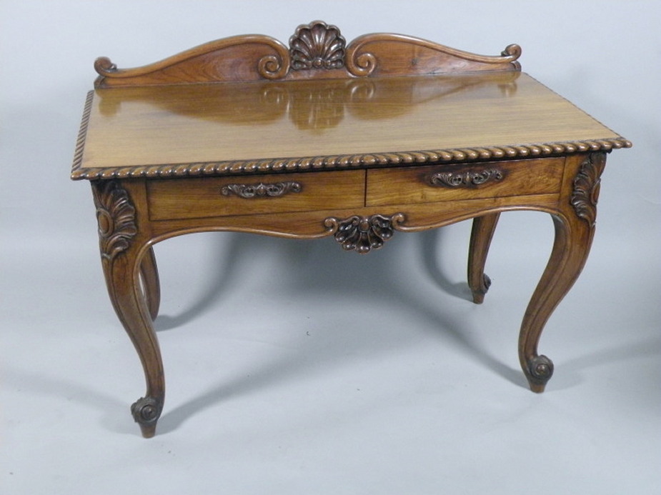 A 19thC Colonial serving table in the Irish style, with a raised back, the top with a gadrooned