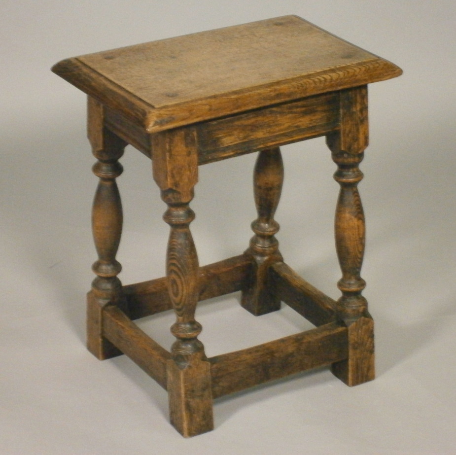 Two oak stools, a joint stool in 16thC style with turned supports, and another stool on end supports