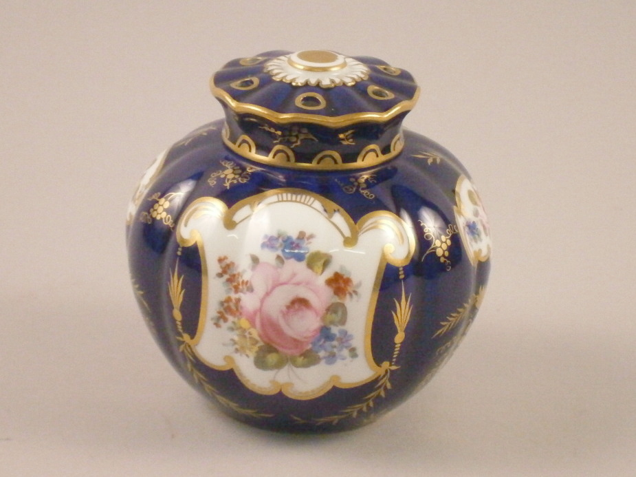 A Royal Crown Derby pot pourri jar and cover, painted with flowers on cobalt blue ground picked