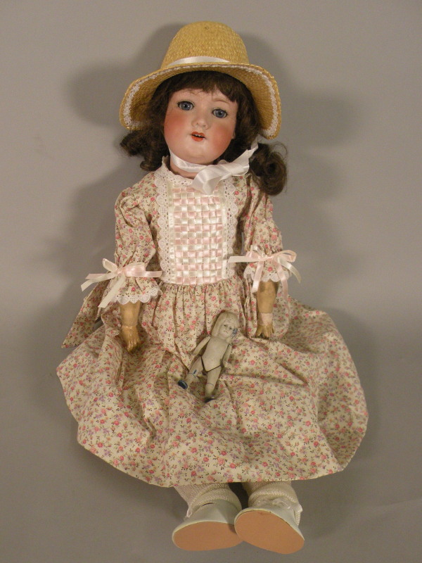 An Armand Marseille 390 bisque headed doll, with composition limbs, later dress, etc, inscribed