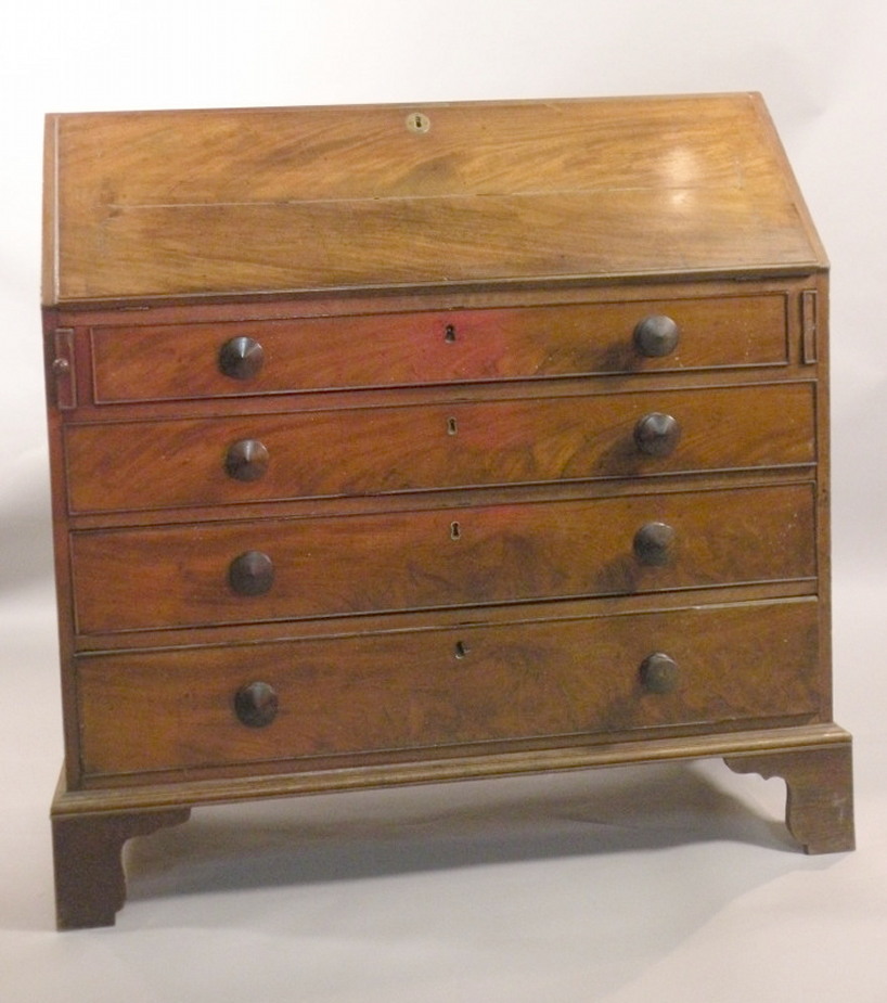 A early 19thC mahogany and oak bureau, the fall front enclosing a fitted interior above four