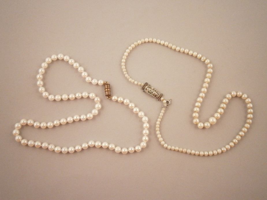 Two cultured or pearl simulated necklaces