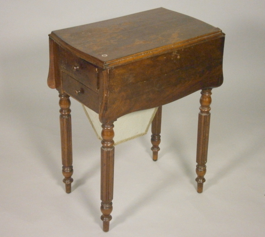 A 19thC figured mahogany work table, the shaped with two drop leaves above two drawers on reeded