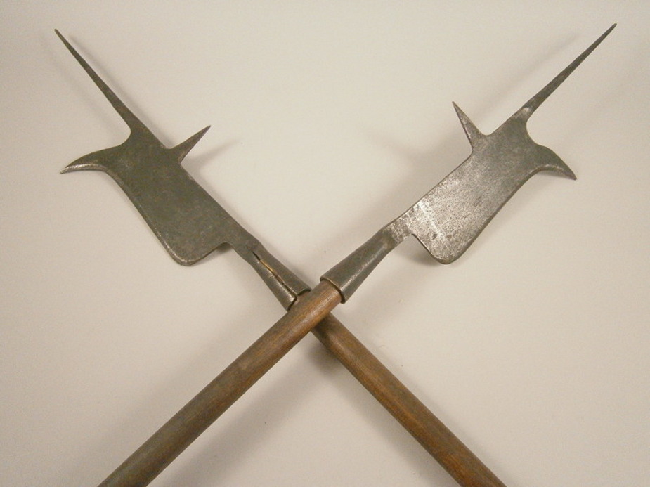 A pair of 19thC steel halberds, each with a later turned wooden handle, 235cm long overall