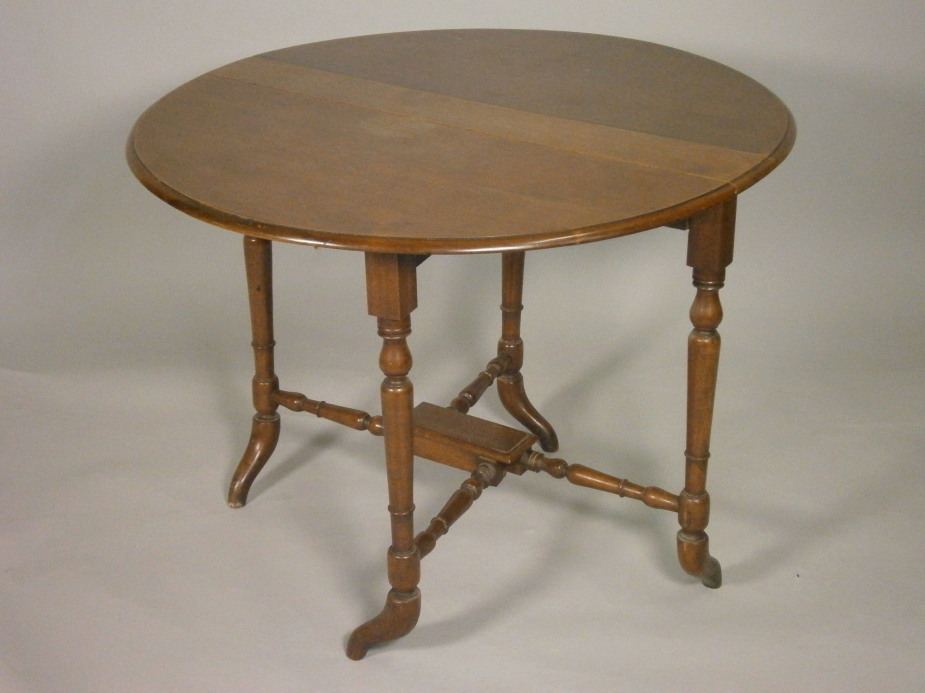 A Victorian walnut Sutherland table, the oval top on turned supports, 88cm wide.