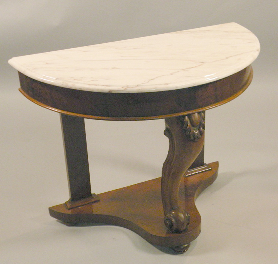 A Victorian walnut and marquetry table, with an ebonised border on turned support with leaf carved