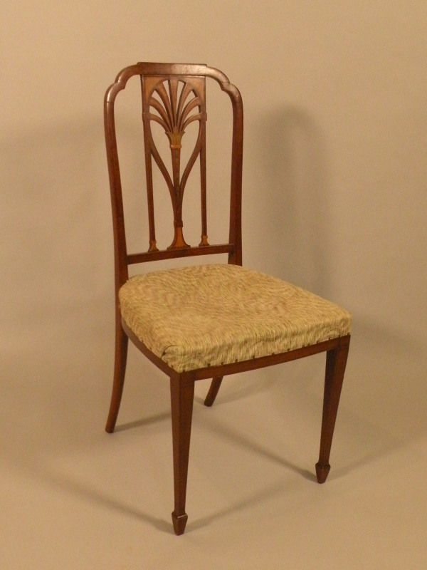 An Edwardian mahogany and marquetry bedroom chair, with a pierced back and padded seat on square