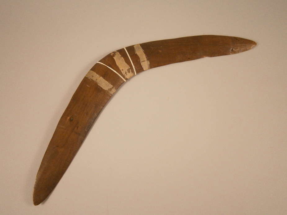 Tribal Art. An Australian Aboriginal boomerang with three white stripes, 56cm wide Provenance; Given