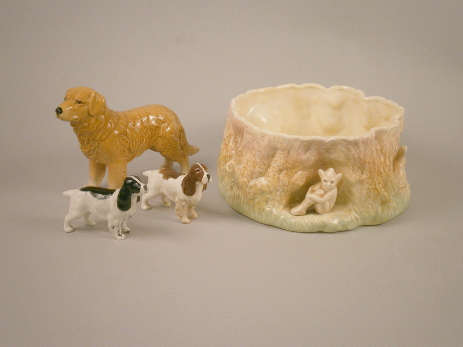 A brown and black Beswick cocker spaniel, a ceramic labrador and a Sylvac bowl applied with pixies