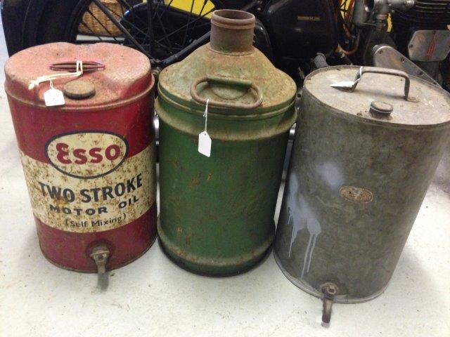 An Esso two-stroke Motor Oil five gallon cylindrical can, a Castrol five gallon cylindrical can