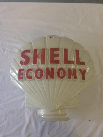 A Shell Economy glass globe, with fading to one side and damaged neck.