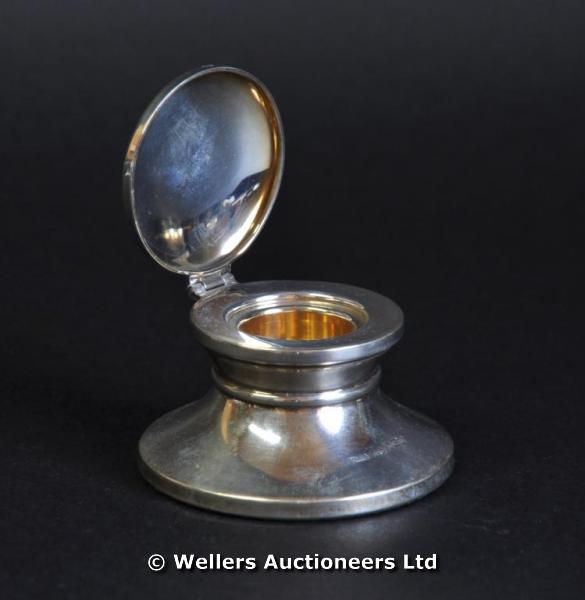 "A silver capstan form inkwell, Birmingham 1991, makers mark B&Co, filled. "