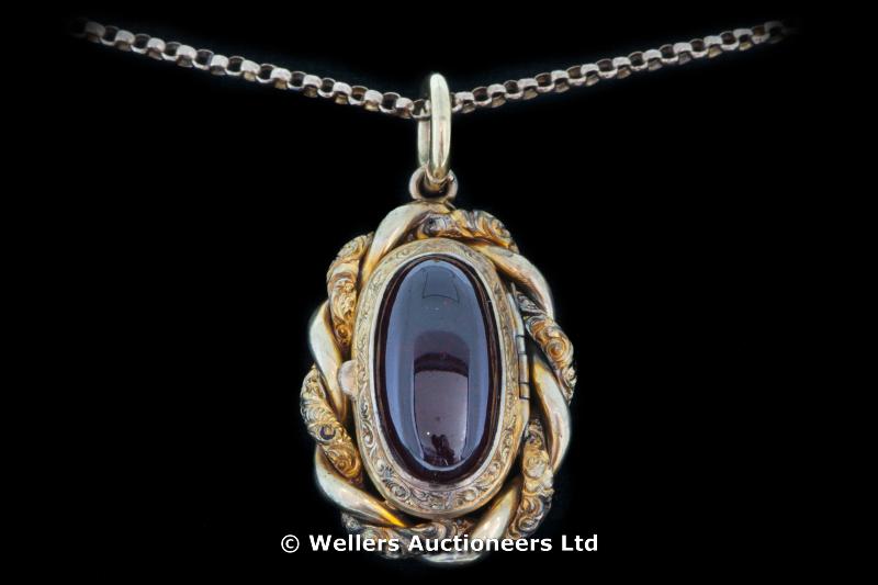 "Victorian two tone garnet locket, cabochon cut garnet in a yellow metal twist border, on a yellow