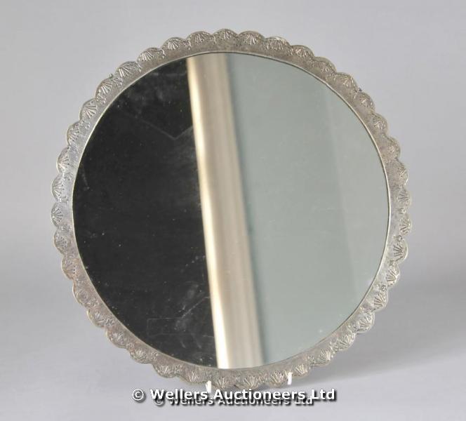 "A circular Turkish white metal mirror, the back embossed"