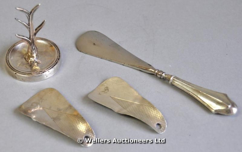 "A pair of silver shoehorns, with fish crests, 1932; another silver shoehorn, 1915; and a silver