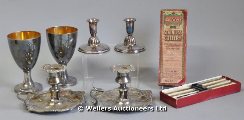 A pair of Sheffield plate chambersticks; a pair of goblets; a pair of candlesticks; and a cased