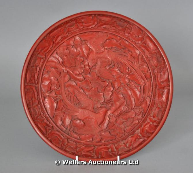 "Chinese cinnabar lacquer style circular dish, decorated with phoenix, gold Ming mark to base"