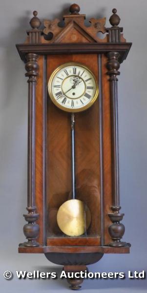 "A late 19thC Vienna regulator, white enamel dial with Roman numerals, winder, weight & pendulum,