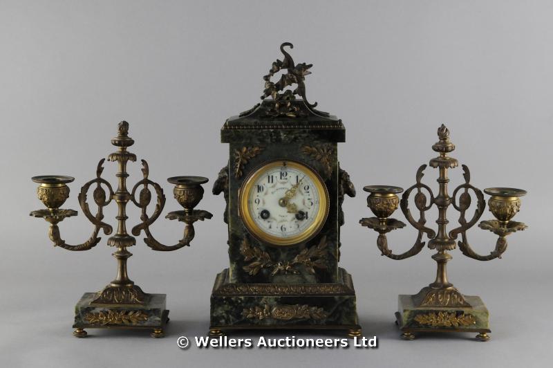 "A French green marble clock garniture, the movement stamped Japy Freres, striking on a gong, the