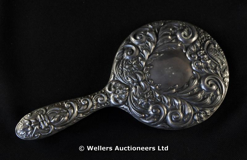 "A silver backed hand mirror, foliate scrolls, Birmingham 1992 "