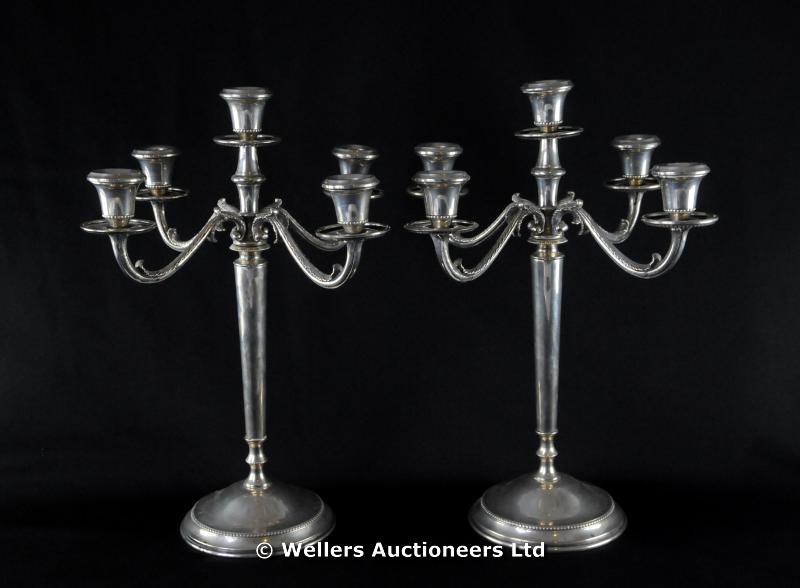 "A pair of 800 standard white metal five light candelabra, beaded rims with foliate scrolls to arms,