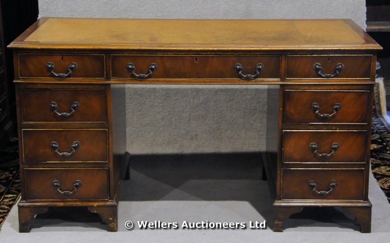 "A reproduction pedestal desk with three frieze drawers an three drawers to each pedestal, 137 x