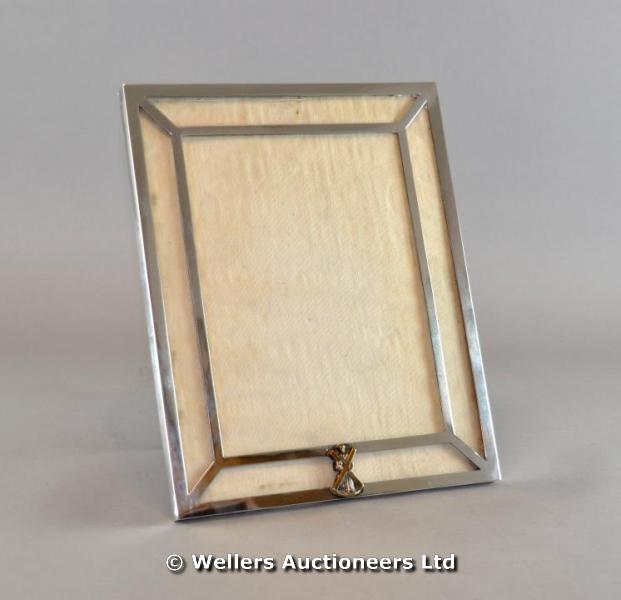 "A rectangular silver frame with gilt metal figural crest, makers mark GM Co. (Gorham