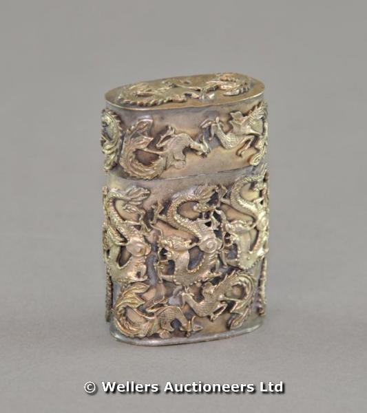 "A 20thC Chinese white metal cylindrical container & cover decorated with scaly dragons, signature