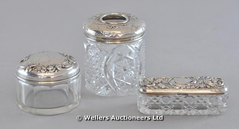 "Three silver top dressing table pots, glass bodies "