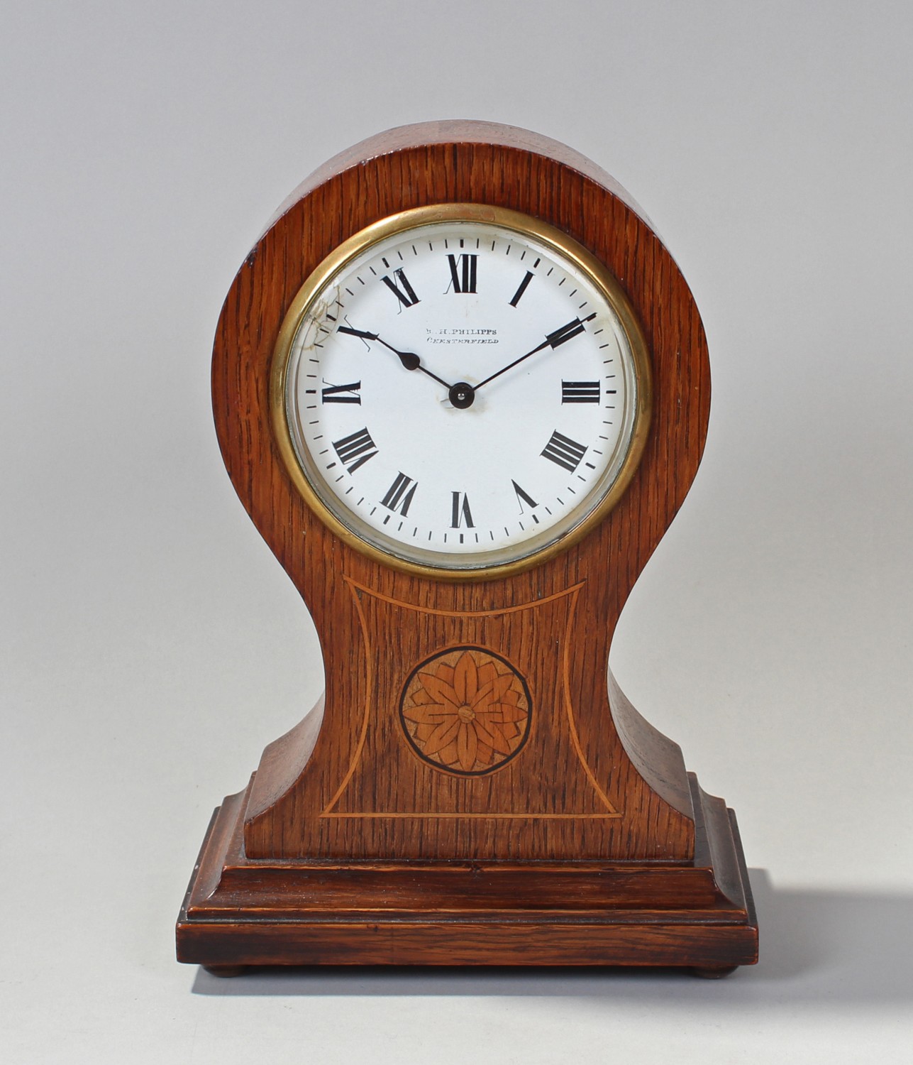 Edwardian Oak and inlaid balloon mantel clock, the case with floral motif inlay below circular white