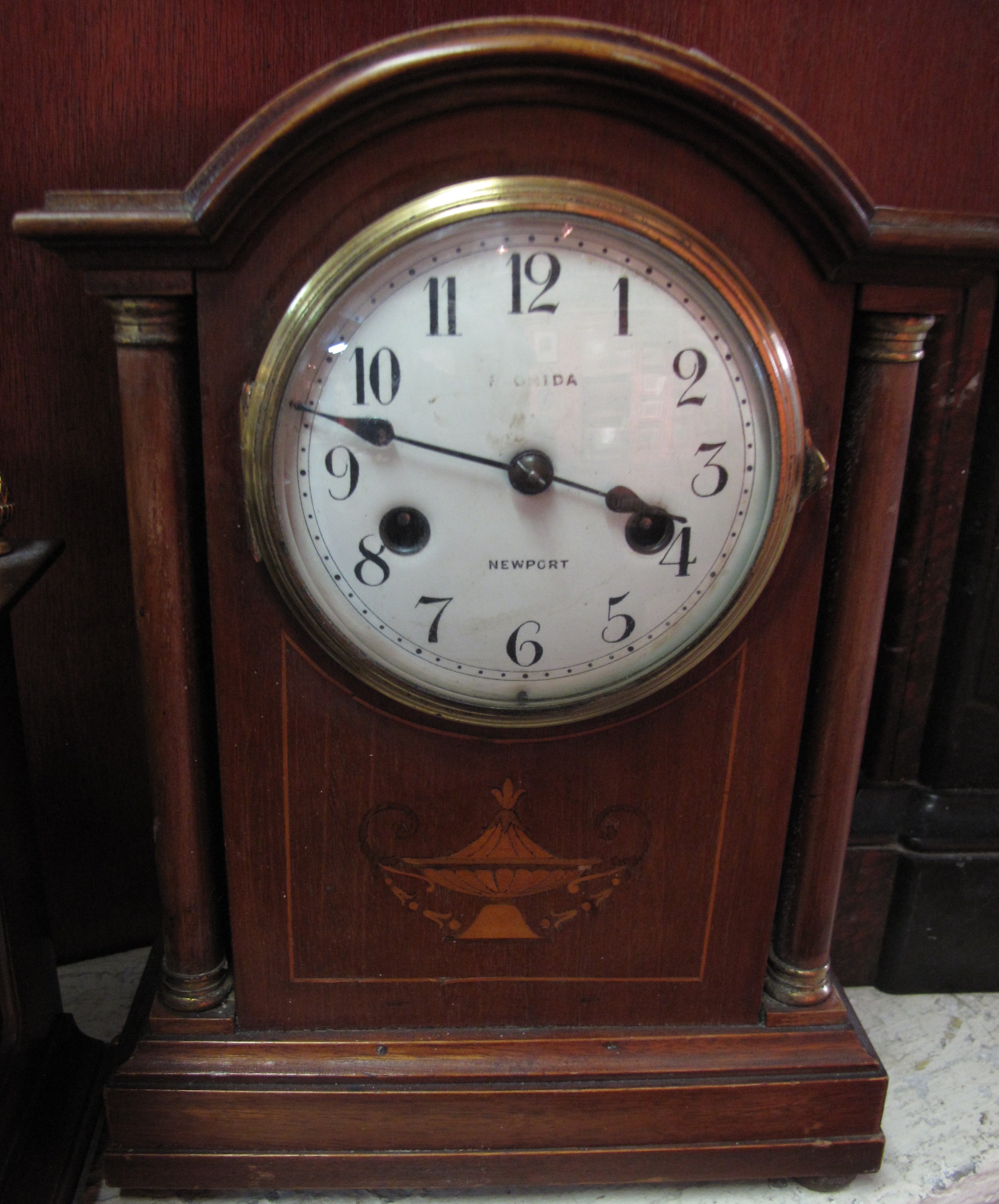 Edwardian inlaid mahogany architectural two train mantle clock with white enamel face.