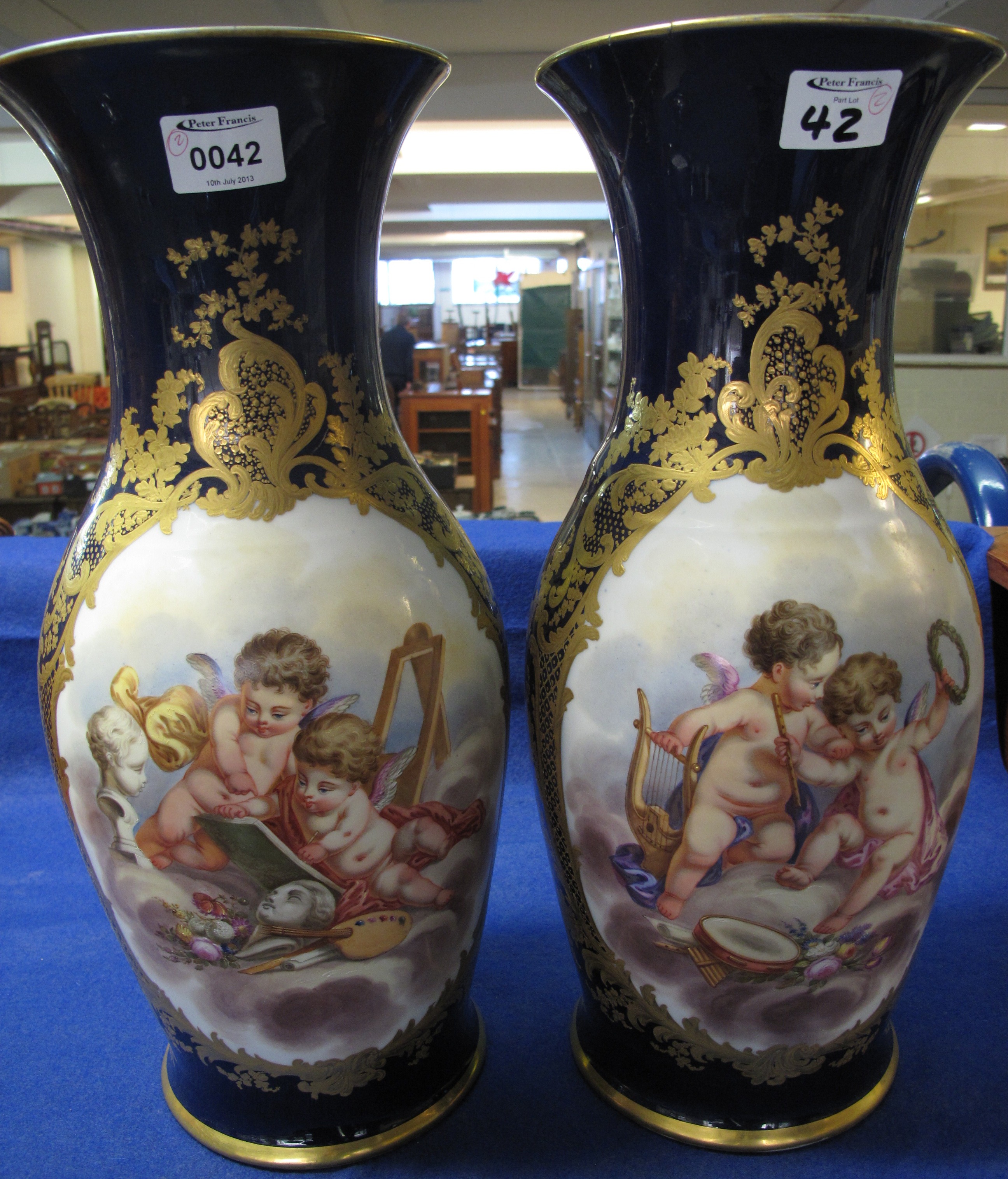 Pair of 19c continental porcelain baluster vases decorated with transfer printed panels of Cherubs